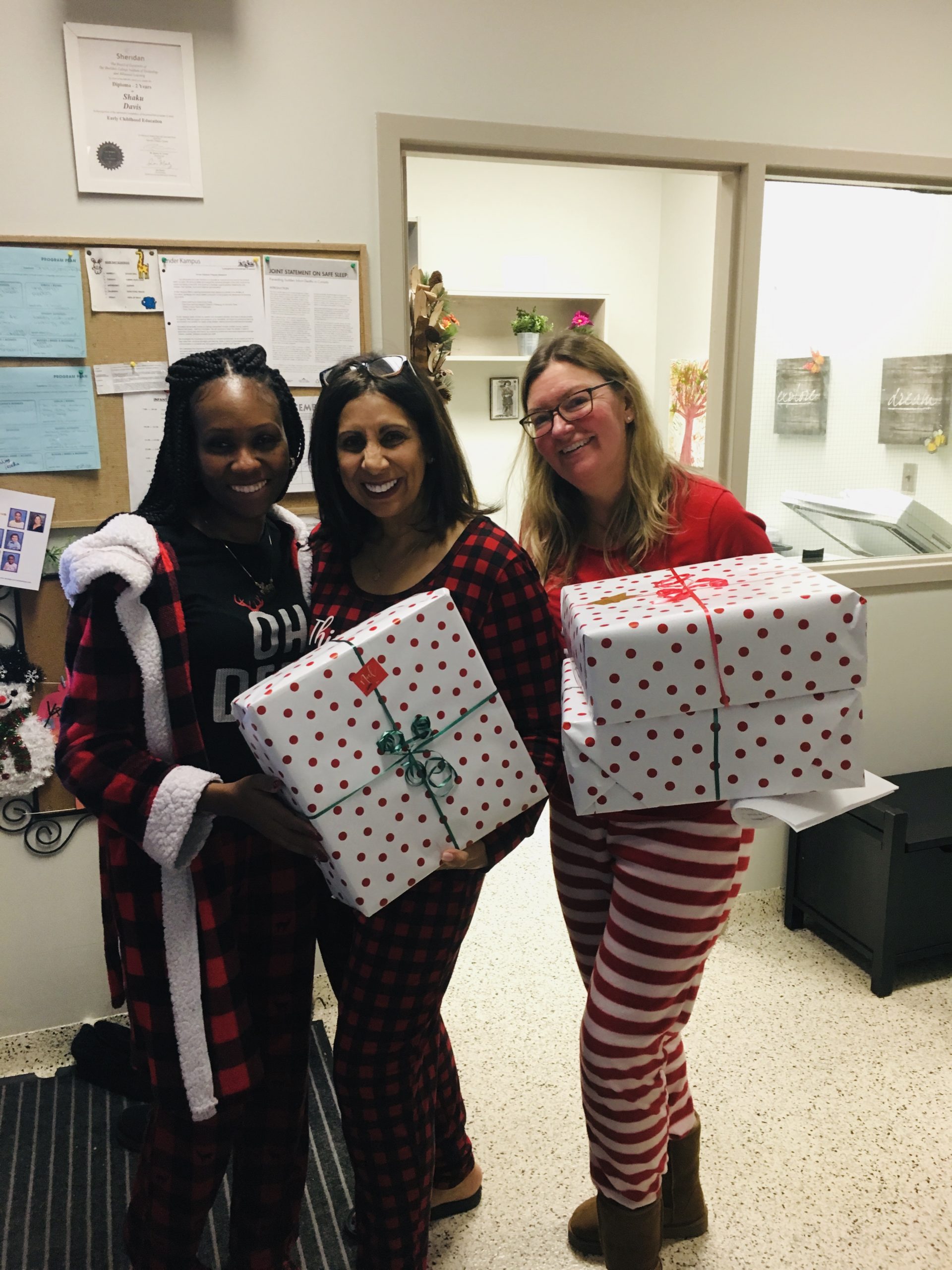 Kinder Kampus staff dressed in holiday outfits with presents